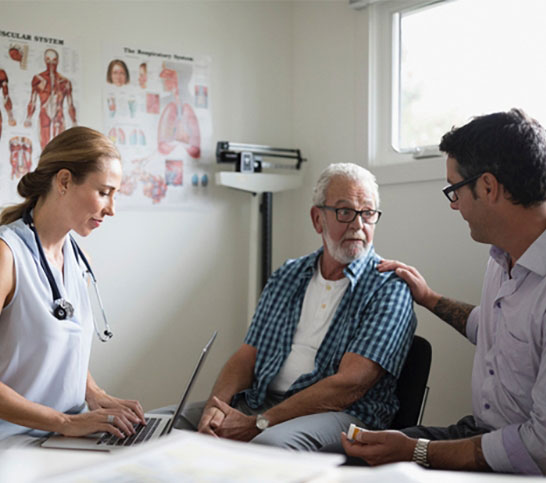 Image of a doctor and two men talking to each other - PE